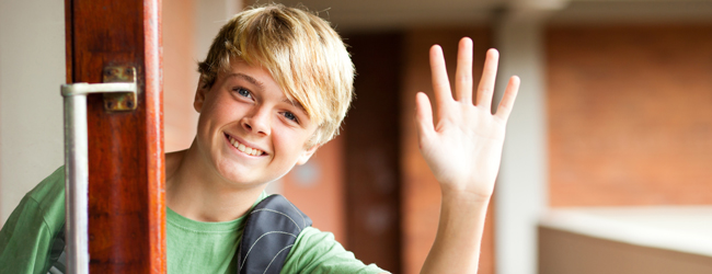 A young boy tells his experience with Oxford Summer Schools A young blond boy with green T-Shirt waving his hand